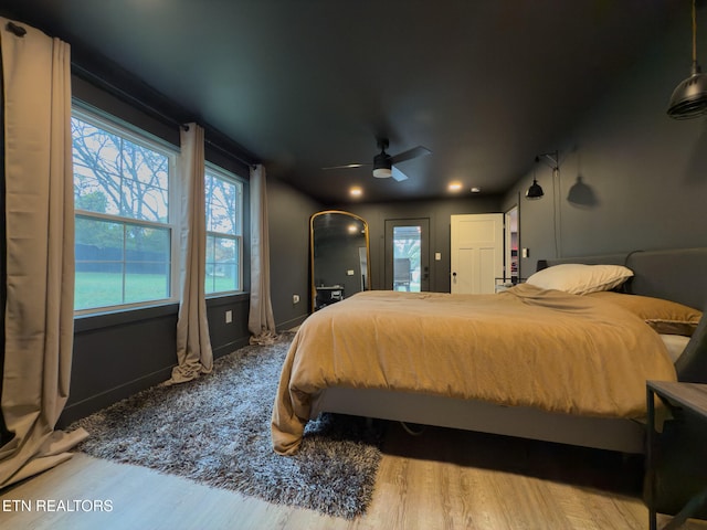 bedroom with hardwood / wood-style floors and ceiling fan