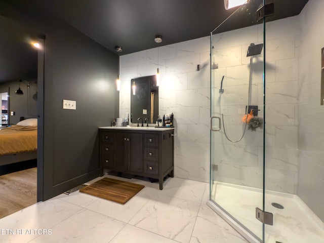 bathroom featuring vanity, hardwood / wood-style floors, and a shower with door