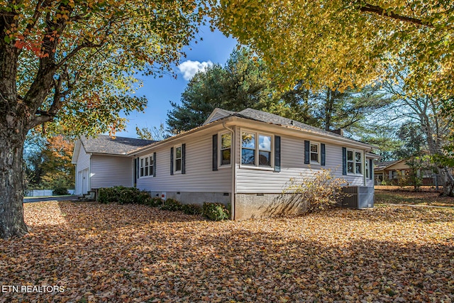 view of side of home featuring central AC unit