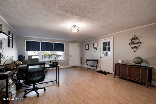 office with ornamental molding, light hardwood / wood-style floors, and a textured ceiling