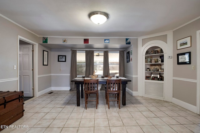 tiled dining space with built in features and crown molding