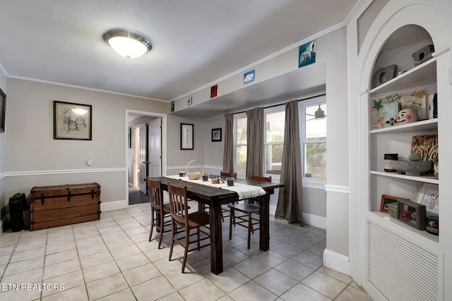 dining area featuring ornamental molding and light tile patterned floors