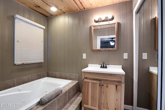 bathroom featuring wood ceiling, vanity, a relaxing tiled tub, and wood walls