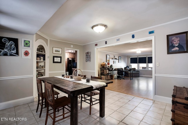 tiled dining room with built in shelves and crown molding