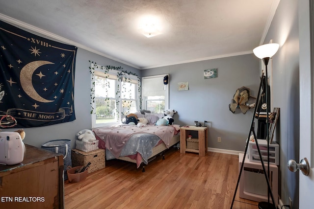 bedroom featuring light hardwood / wood-style floors and crown molding