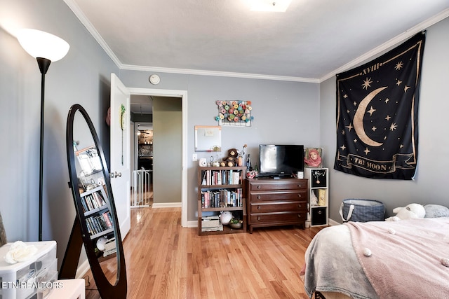 bedroom with light hardwood / wood-style flooring and crown molding