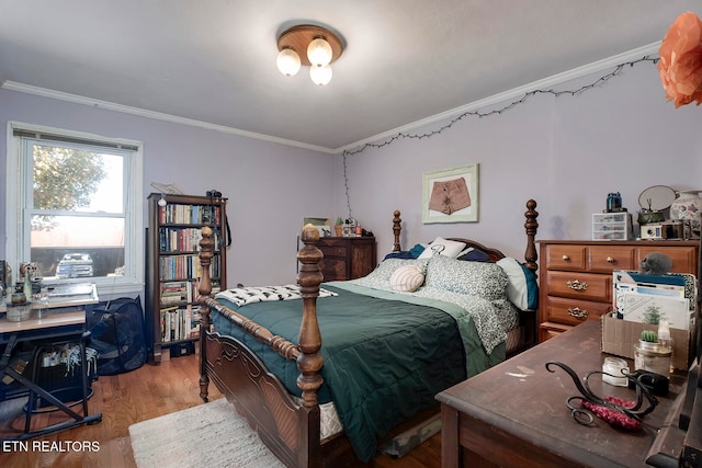 bedroom with light wood-type flooring and ornamental molding