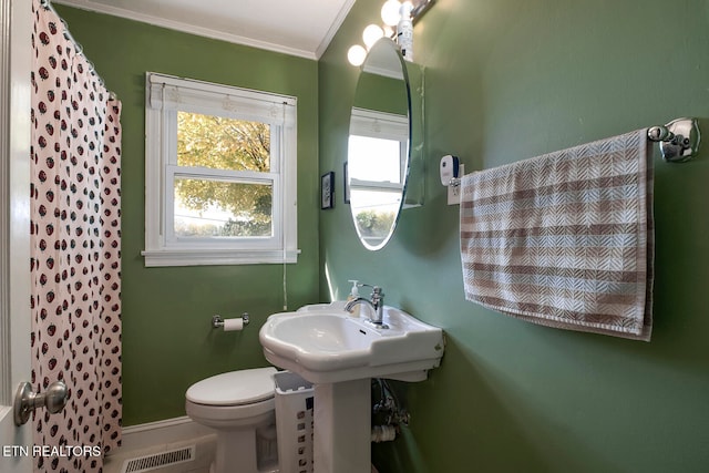 bathroom with walk in shower, toilet, and crown molding