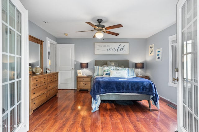 bedroom with dark wood-type flooring, ceiling fan, and french doors