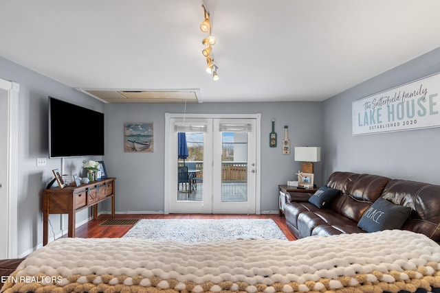 living room featuring track lighting and dark wood-type flooring