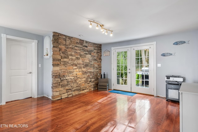 empty room with french doors and wood-type flooring