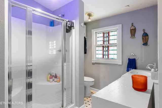 bathroom with toilet, a shower with shower door, and vanity