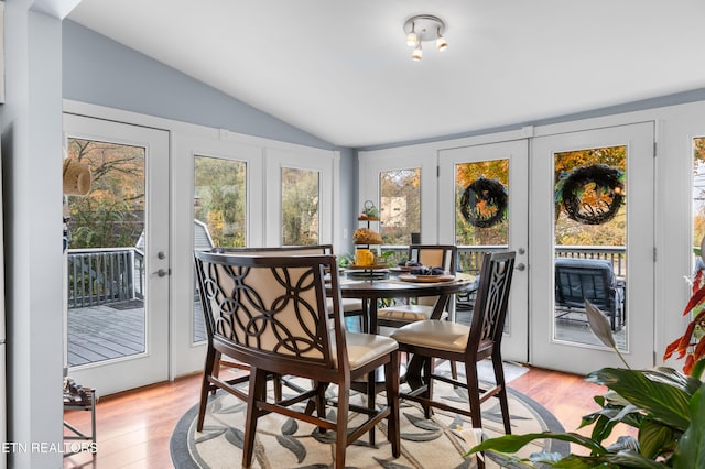 sunroom / solarium featuring french doors and vaulted ceiling