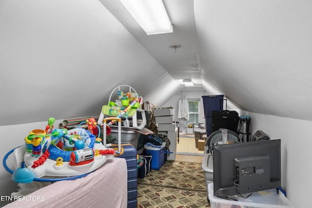 recreation room with lofted ceiling and carpet