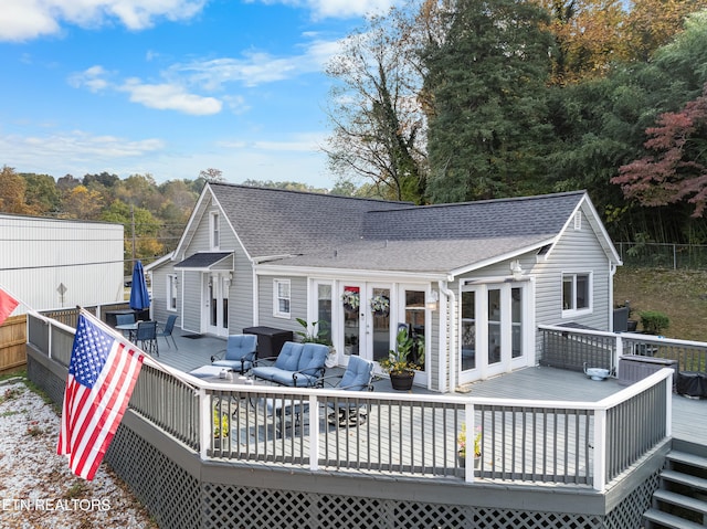 rear view of property with french doors and a deck