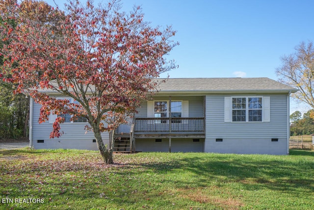 rear view of property with a yard and a wooden deck