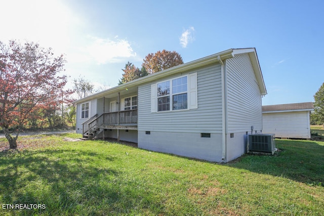 exterior space featuring a yard and central air condition unit