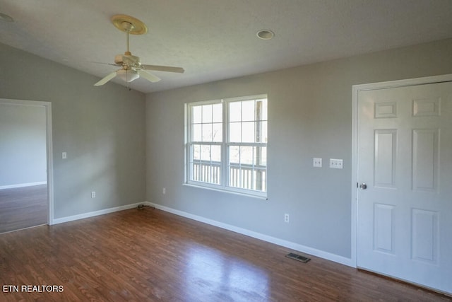 unfurnished room featuring ceiling fan and dark hardwood / wood-style flooring