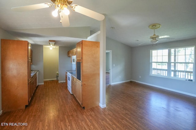 kitchen featuring vaulted ceiling, dark hardwood / wood-style floors, white appliances, and ceiling fan