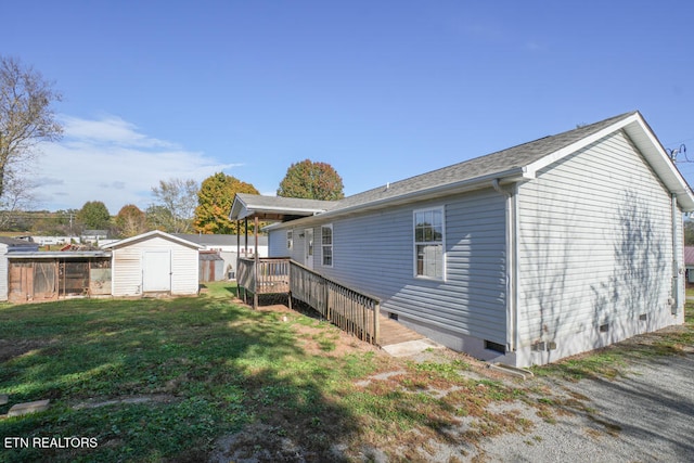 view of side of home with a storage unit and a lawn