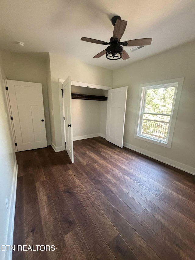 unfurnished bedroom featuring a closet, ceiling fan, and dark wood-type flooring