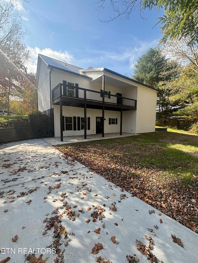 rear view of house with a patio area and a wooden deck