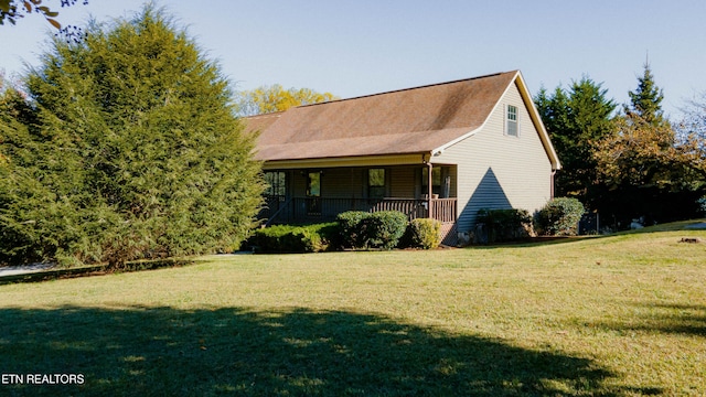 view of front of home featuring covered porch and a front yard