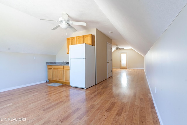 bonus room with light hardwood / wood-style floors, vaulted ceiling, and ceiling fan