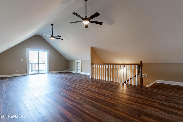 bonus room featuring built in shelves, ceiling fan, lofted ceiling, and dark wood-type flooring