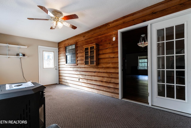 interior space with ceiling fan