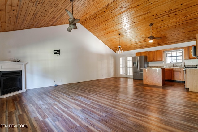 unfurnished living room featuring ceiling fan, sink, dark wood-type flooring, and high vaulted ceiling