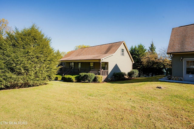 view of home's exterior with a porch and a lawn