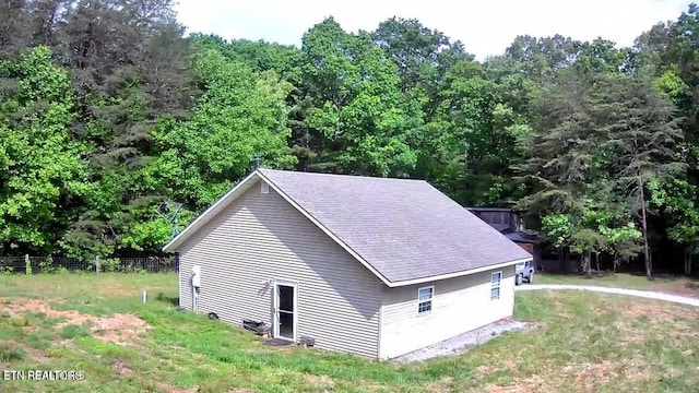 view of side of home with a yard