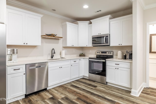 kitchen featuring white cabinetry, sink, appliances with stainless steel finishes, and dark wood-type flooring