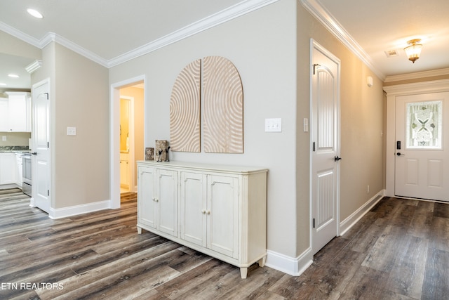 foyer with ornamental molding and dark wood-type flooring