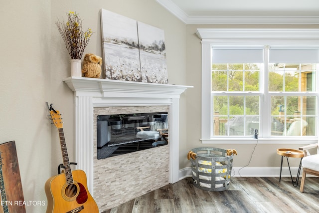 sitting room with hardwood / wood-style floors and crown molding