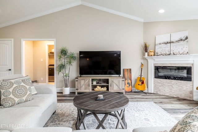 living room with lofted ceiling, hardwood / wood-style flooring, and crown molding