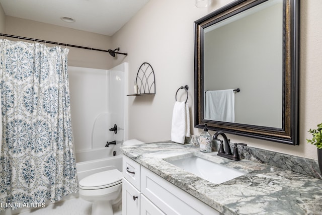 full bathroom featuring vanity, shower / bath combination with curtain, and toilet