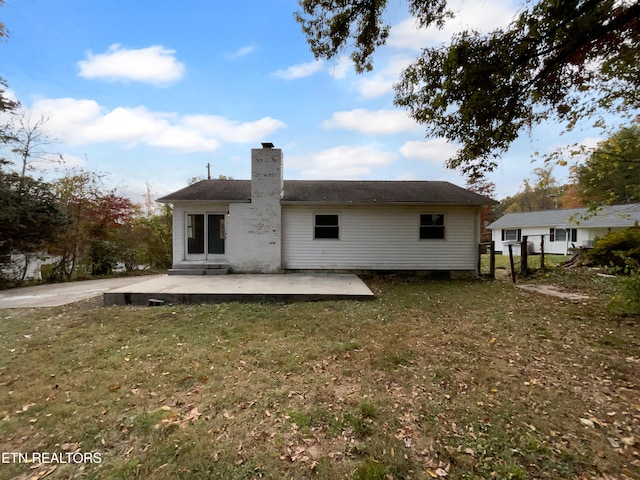 back of house with a yard and a patio area