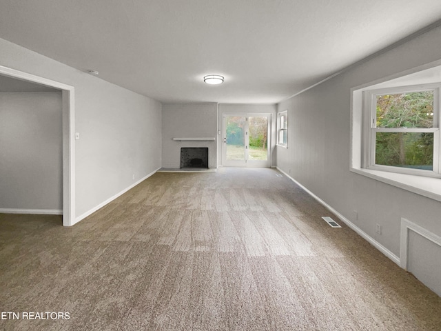 unfurnished living room featuring carpet