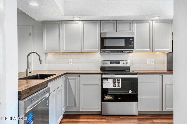 8709 Olde Colony Trl Unit 12, Knoxville, TN 37923 - kitchen featuring stainless steel appliances, butcher block counters, a sink, and decorative backsplash