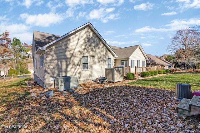 view of property exterior with a yard and central air condition unit