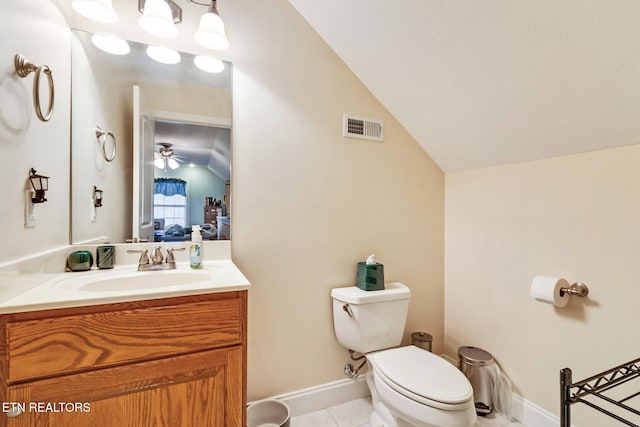 ensuite bathroom with visible vents, toilet, tile patterned floors, vaulted ceiling, and vanity