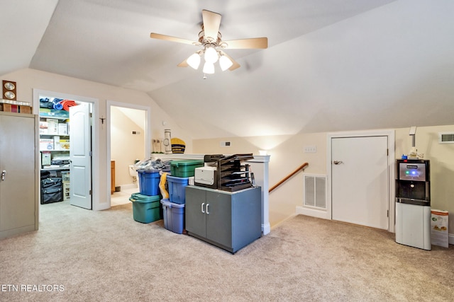 home office featuring carpet floors, lofted ceiling, and visible vents