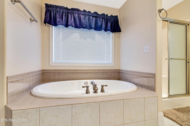 full bathroom with a wealth of natural light, an enclosed shower, and a bath