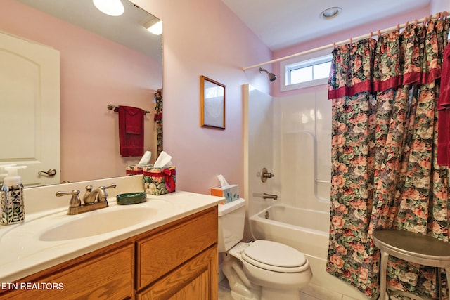 full bathroom featuring toilet, vanity, and shower / tub combo with curtain