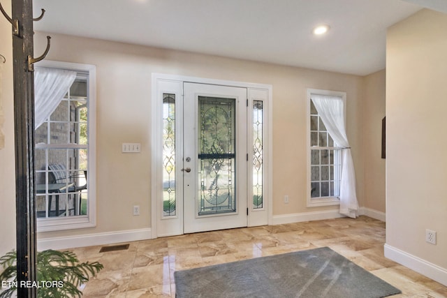 doorway with recessed lighting, visible vents, and baseboards