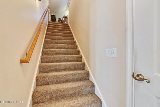 stairway with carpet and baseboards