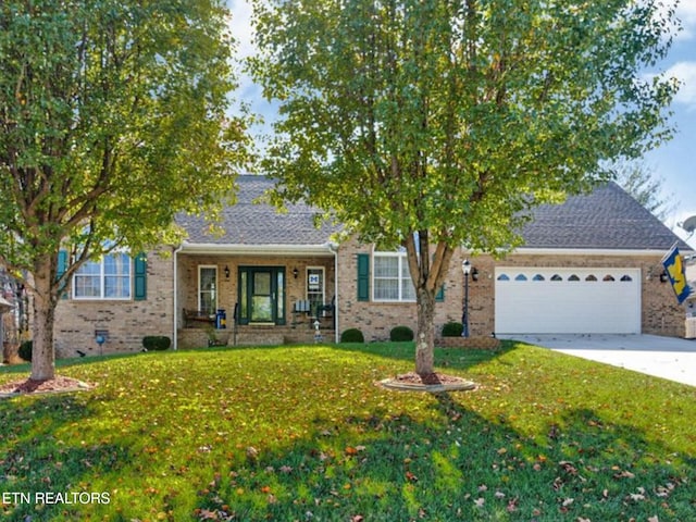 view of front of property featuring brick siding, concrete driveway, covered porch, a front yard, and a garage