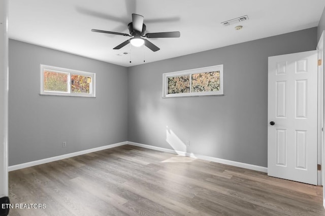 unfurnished room featuring hardwood / wood-style flooring and ceiling fan